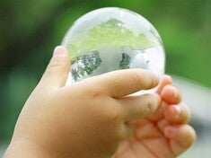 Sustainability Portal Thumbnail - child with globe